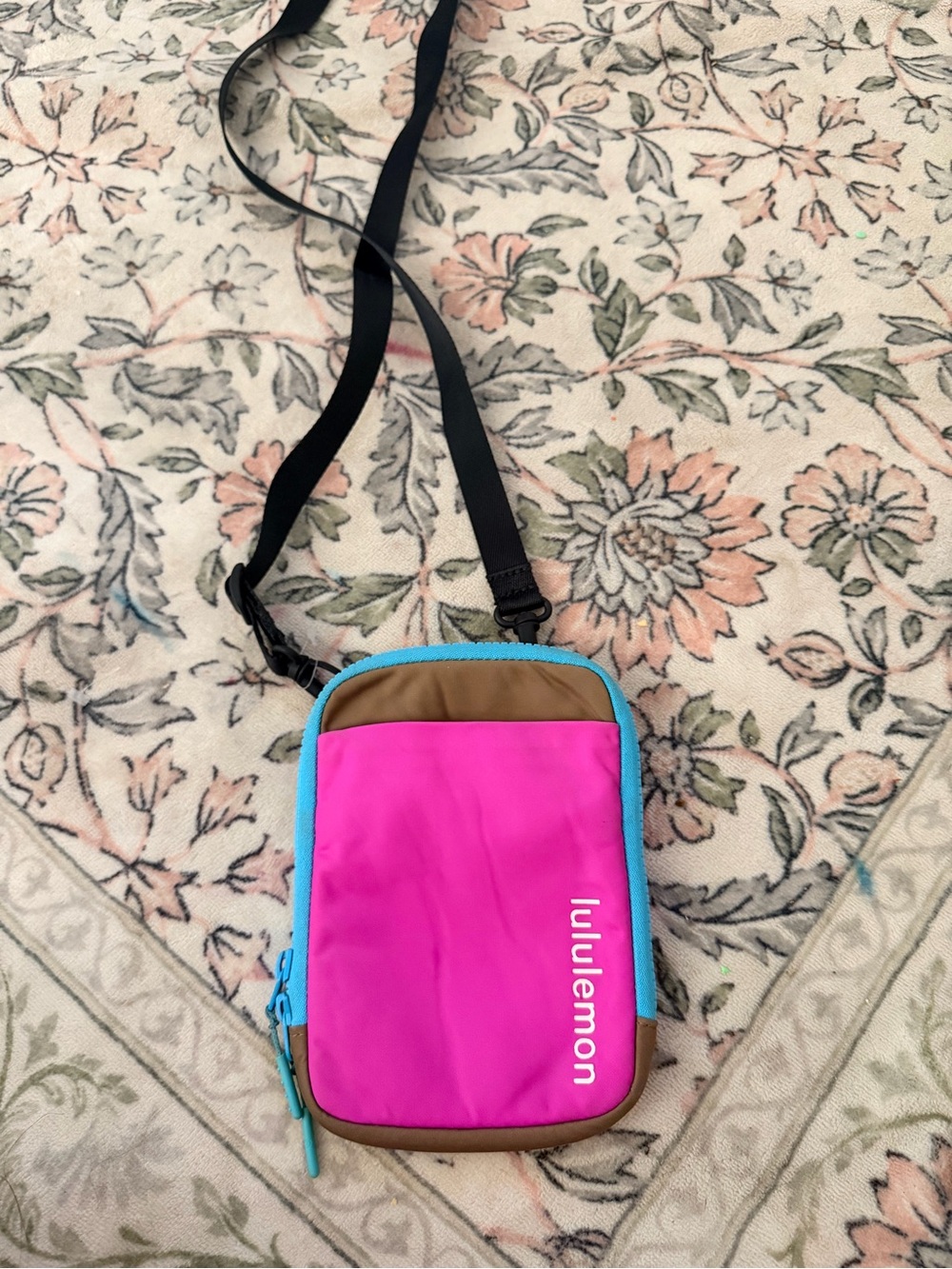 lululemon pink crossbody pouch with blue trim and tan accents